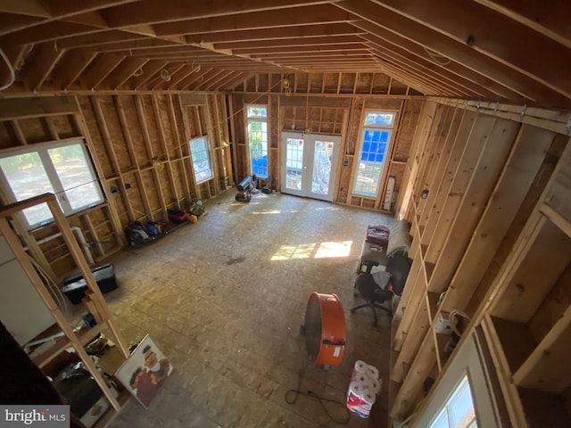 miscellaneous room with french doors, a healthy amount of sunlight, and lofted ceiling