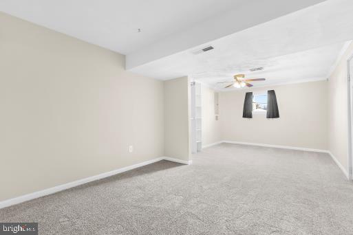 carpeted empty room featuring ceiling fan