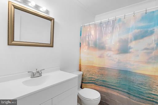 bathroom with vanity, ornamental molding, a shower with curtain, and toilet