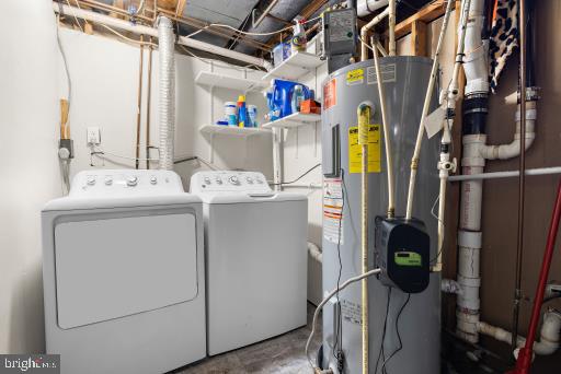 laundry area featuring water heater and washing machine and dryer