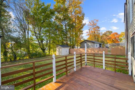 wooden deck featuring a storage unit