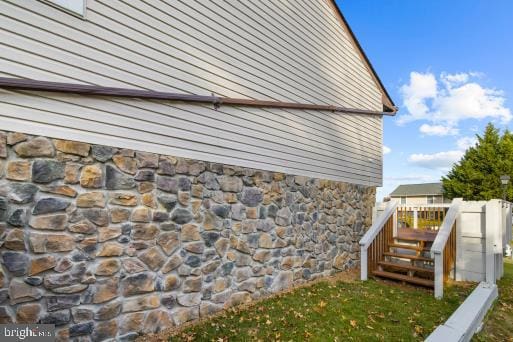 view of side of property with a wooden deck