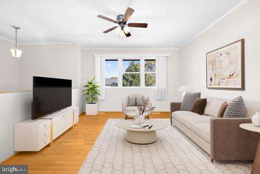 living room with crown molding, light wood-type flooring, and ceiling fan