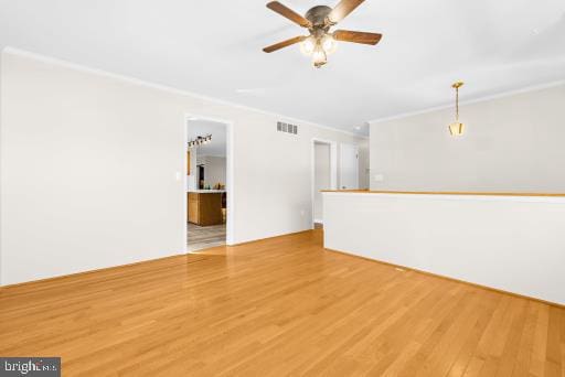 unfurnished living room featuring ornamental molding and hardwood / wood-style floors