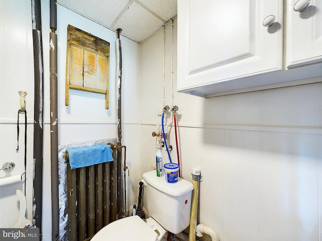 bathroom featuring toilet and a paneled ceiling