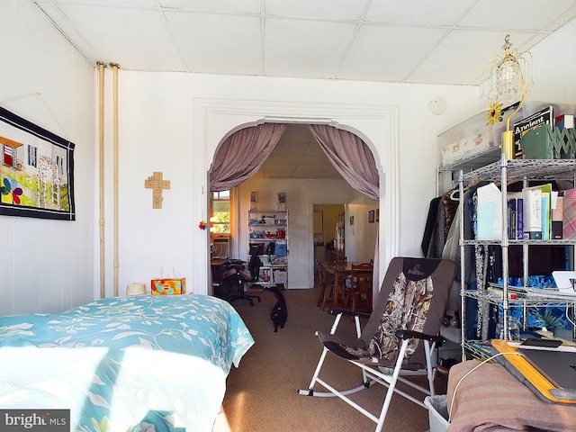 carpeted bedroom with a paneled ceiling