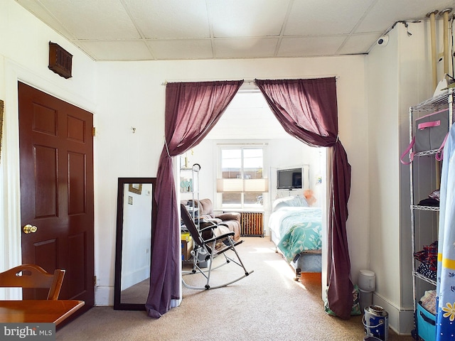 carpeted bedroom with a paneled ceiling