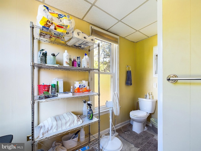 bathroom featuring toilet and a drop ceiling