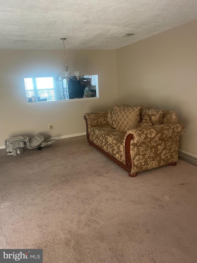 living area with a textured ceiling and carpet