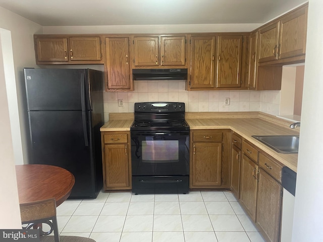 kitchen featuring backsplash, ventilation hood, black appliances, sink, and light tile patterned floors