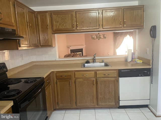 kitchen featuring black electric range, light tile patterned flooring, dishwasher, sink, and range hood