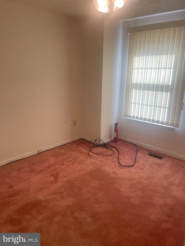 carpeted empty room featuring a textured ceiling and ceiling fan