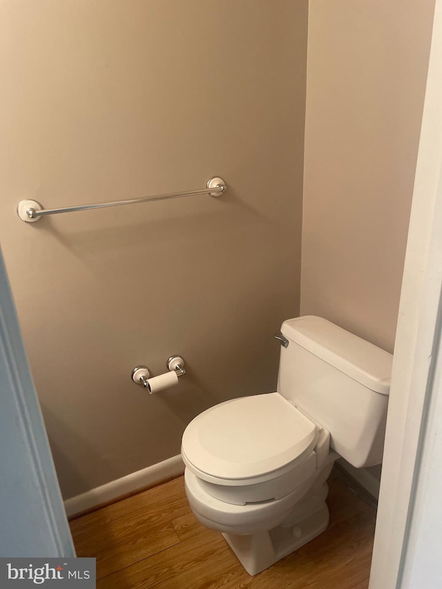 bathroom featuring wood-type flooring and toilet