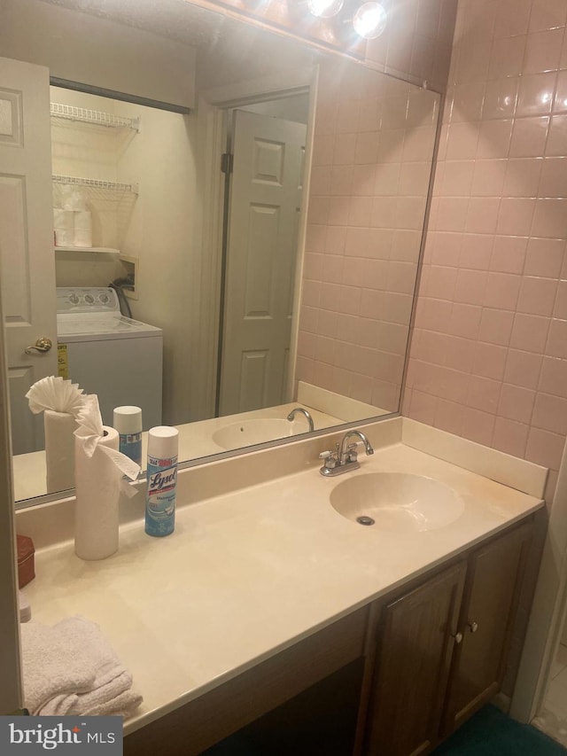 bathroom featuring washer / dryer and vanity