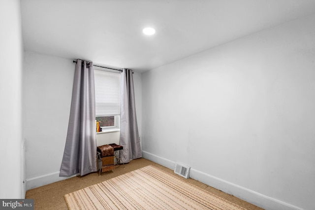unfurnished room with baseboards and recessed lighting