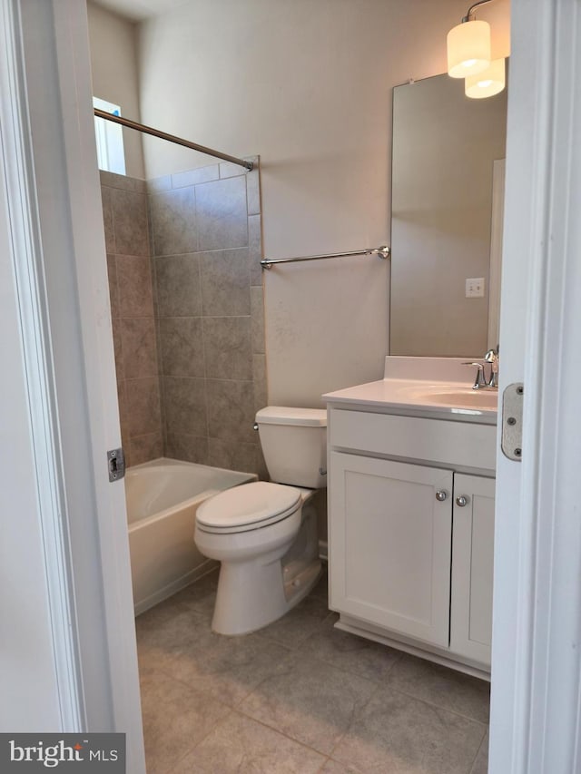 full bathroom featuring vanity, toilet, tiled shower / bath combo, and tile patterned flooring