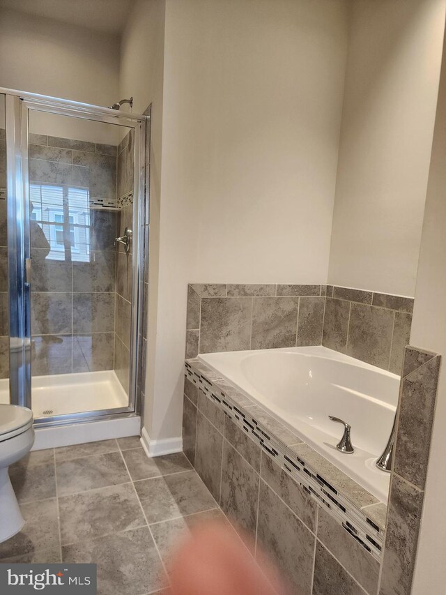 bathroom with toilet, tile patterned floors, and independent shower and bath