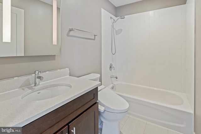 full bathroom featuring tiled shower / bath, vanity, toilet, and tile patterned floors