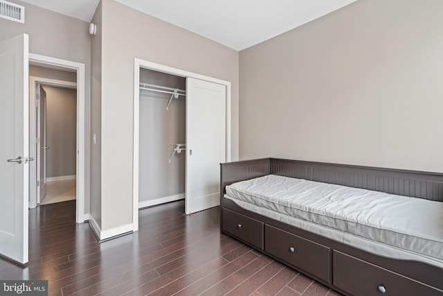 bedroom featuring a closet and dark hardwood / wood-style flooring