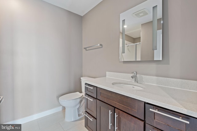 bathroom featuring vanity, toilet, tile patterned floors, and an enclosed shower