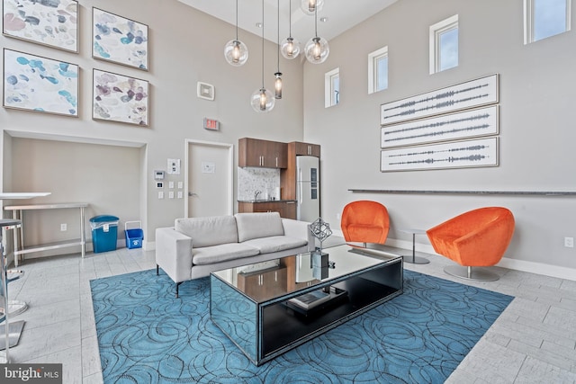 living room featuring sink and a towering ceiling