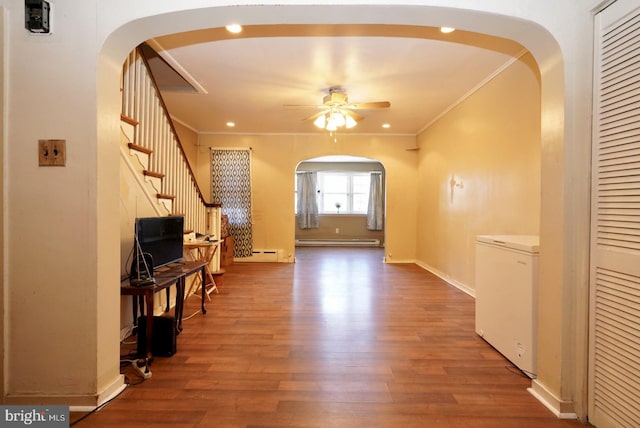 interior space featuring crown molding, wood-type flooring, and a baseboard radiator