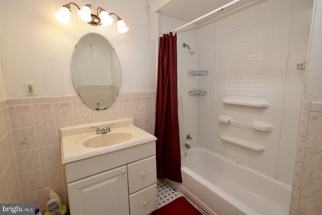 bathroom with vanity, shower / tub combo with curtain, and tile walls