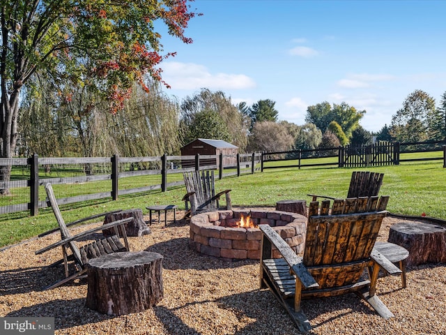 view of yard featuring a fire pit and fence