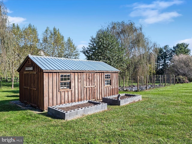 view of outbuilding with an outdoor structure and a garden