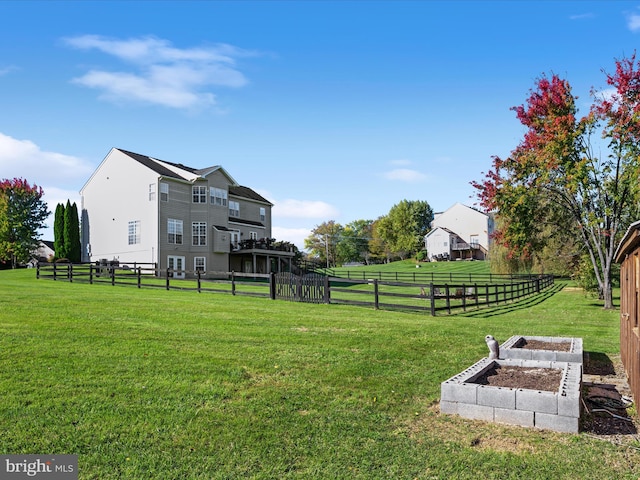 view of yard with a vegetable garden and fence