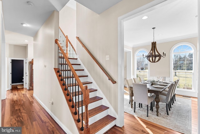 staircase featuring visible vents, baseboards, recessed lighting, wood finished floors, and a notable chandelier