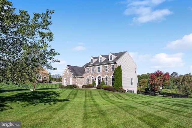 view of front of house with a front yard and fence