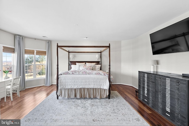 bedroom featuring baseboards and wood finished floors