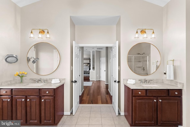 full bathroom featuring tile patterned floors, two vanities, and a sink