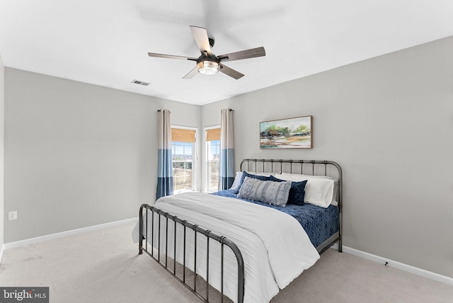 bedroom with visible vents, baseboards, and light colored carpet