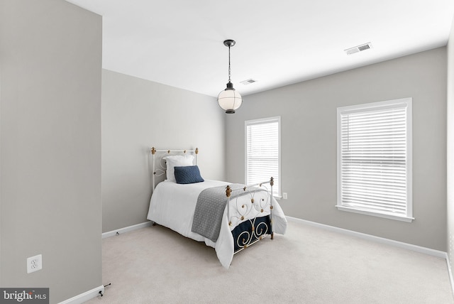 bedroom with baseboards, carpet floors, and visible vents