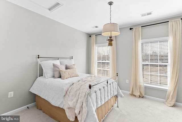 carpeted bedroom featuring visible vents and baseboards