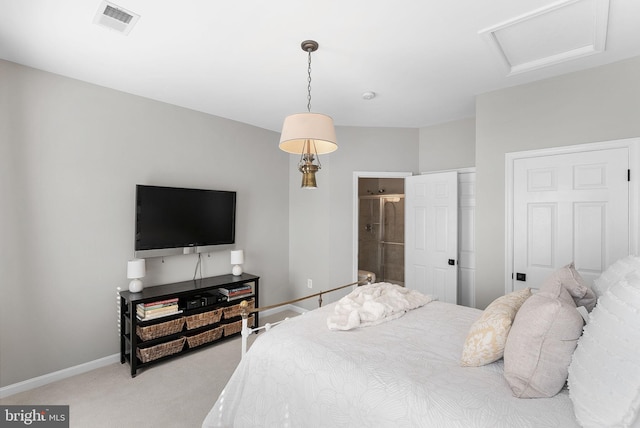 carpeted bedroom featuring ensuite bath, attic access, baseboards, and visible vents