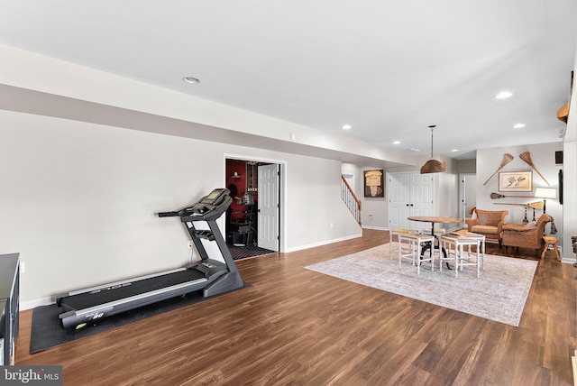 exercise room featuring recessed lighting, dark wood-style floors, and baseboards