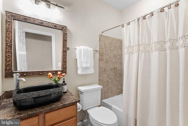 full bathroom with vanity, shower / tub combo, and toilet