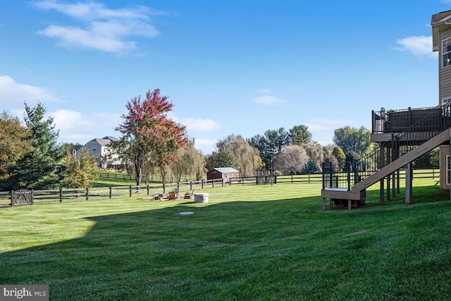 view of yard with stairs and fence