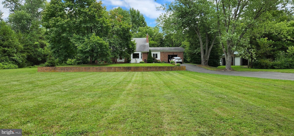 view of front of property with a front yard and a garage