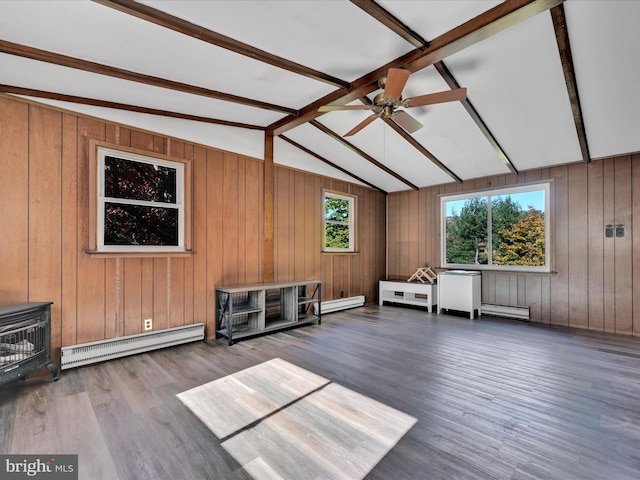 interior space featuring a baseboard radiator, hardwood / wood-style floors, vaulted ceiling with beams, and wood walls