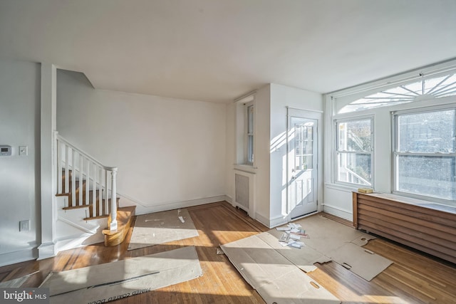 entryway featuring hardwood / wood-style floors and radiator heating unit