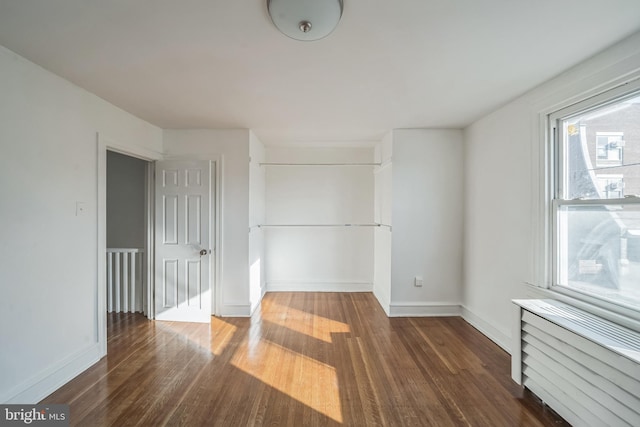 unfurnished bedroom featuring dark hardwood / wood-style floors