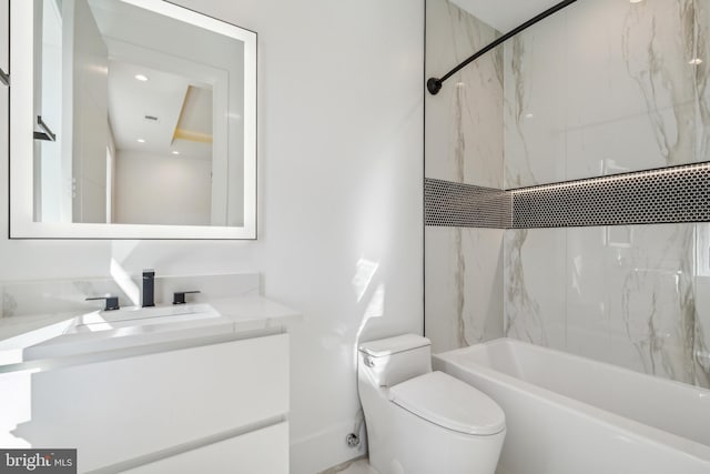 full bathroom with vanity, tiled shower / bath combo, and toilet