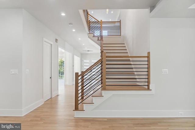 stairs featuring wood-type flooring