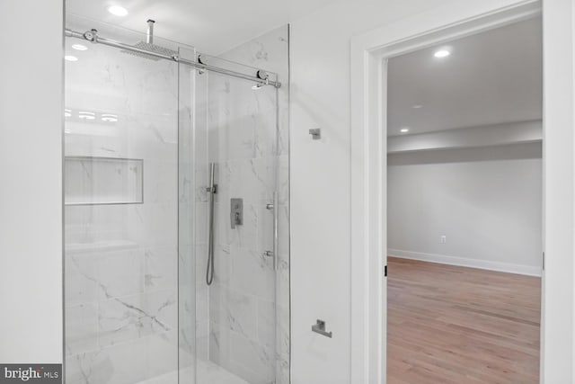 bathroom featuring walk in shower and hardwood / wood-style flooring