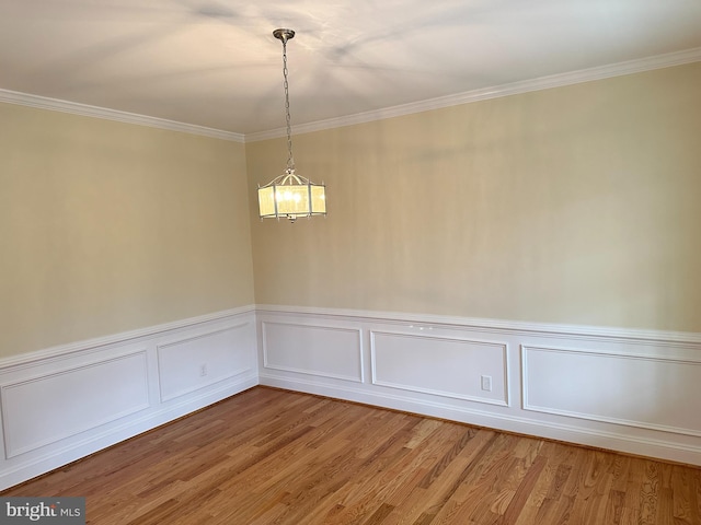 empty room featuring hardwood / wood-style floors and ornamental molding