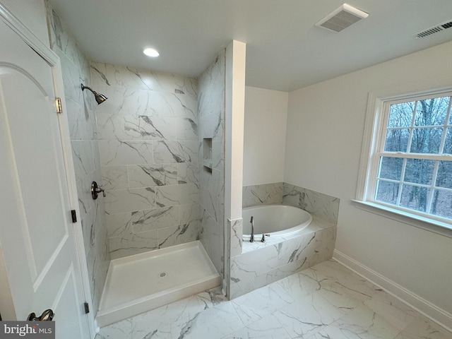 bathroom featuring shower with separate bathtub